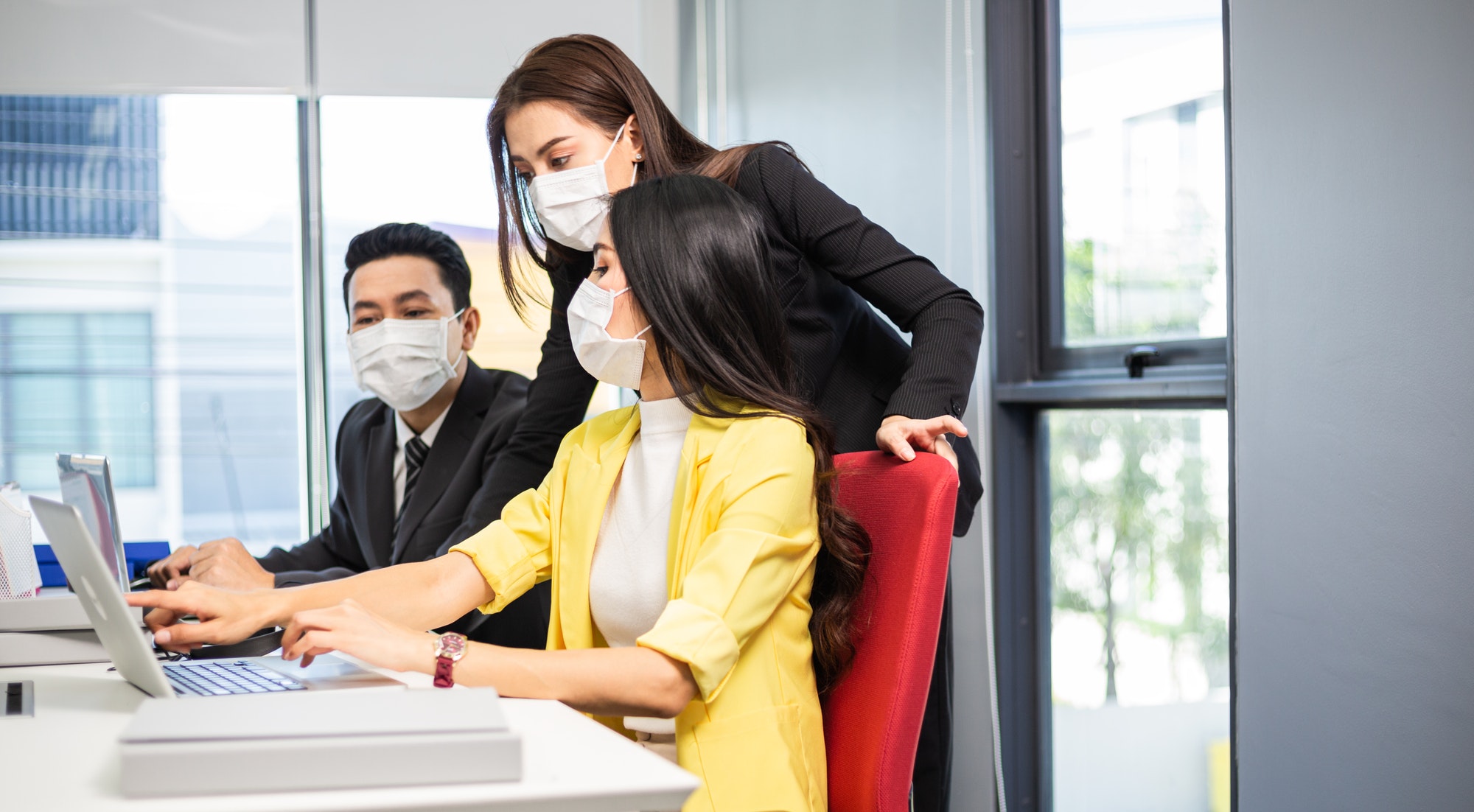 Group of Asian people working and brainstorming at desk together